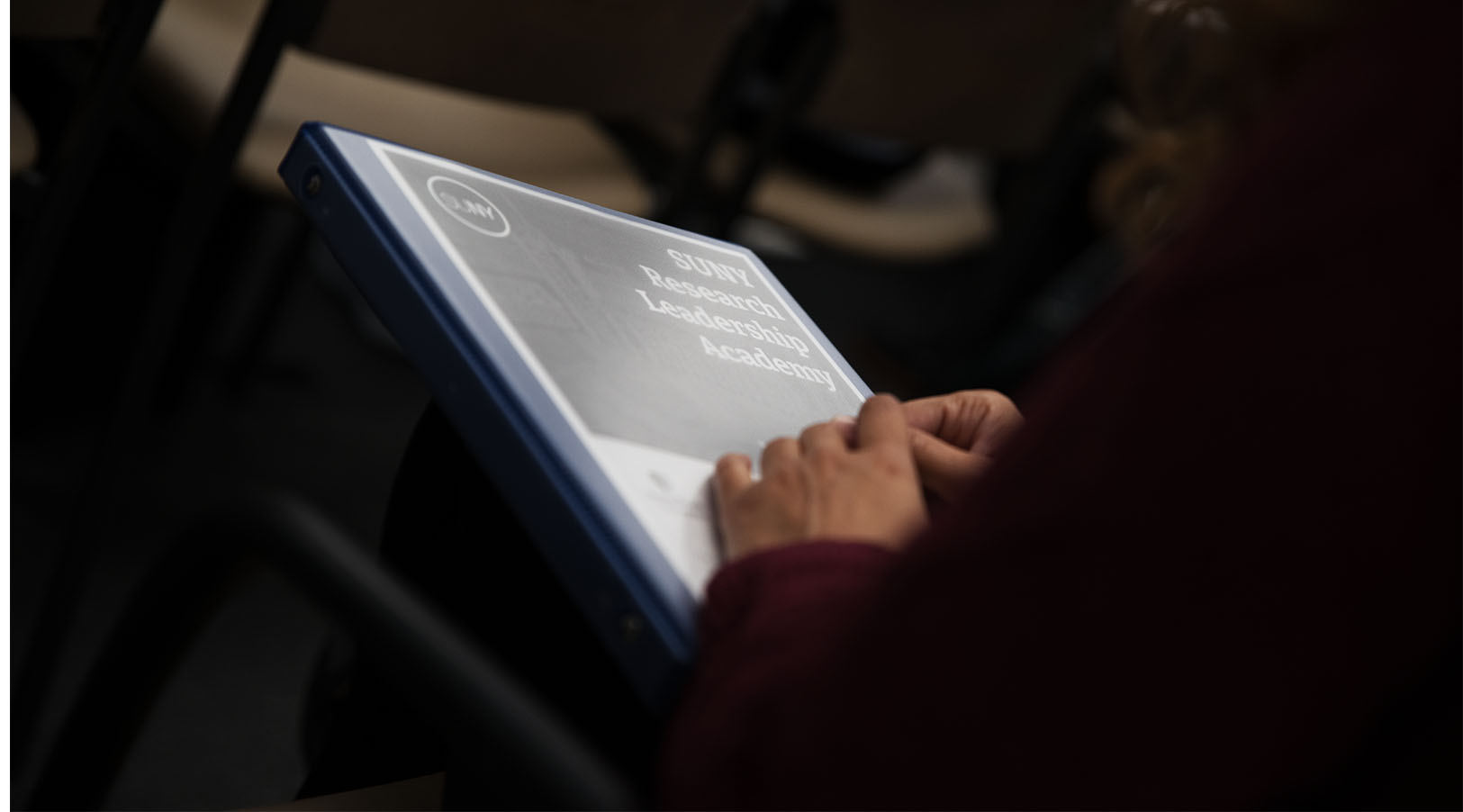 Academy binder in an Academy fellow's hands
