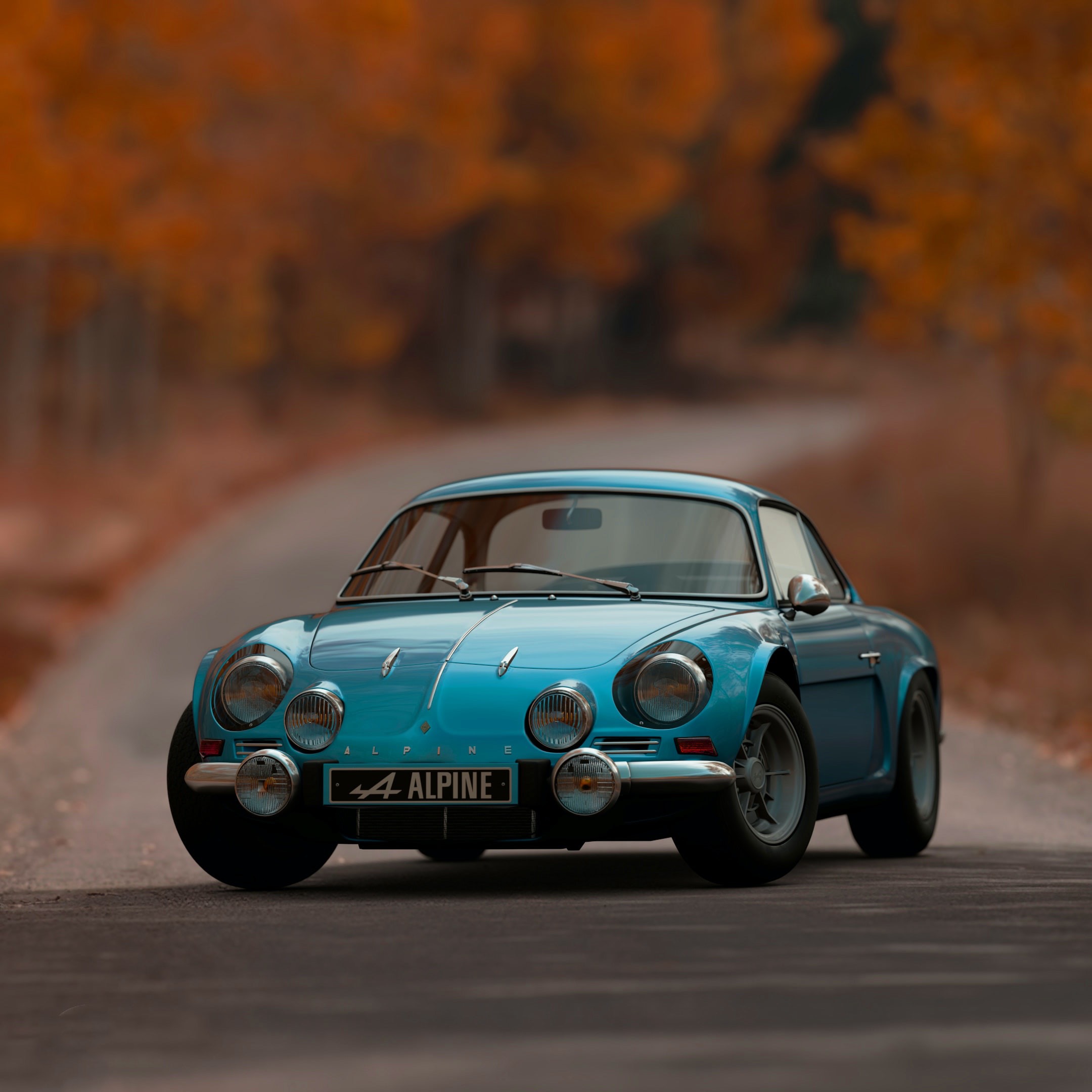 blue automobile on an autumn forest road