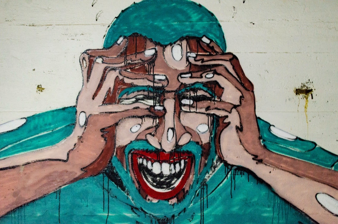photo by Aaron Blanco Tejedor: mural of Black man holding his head in pain