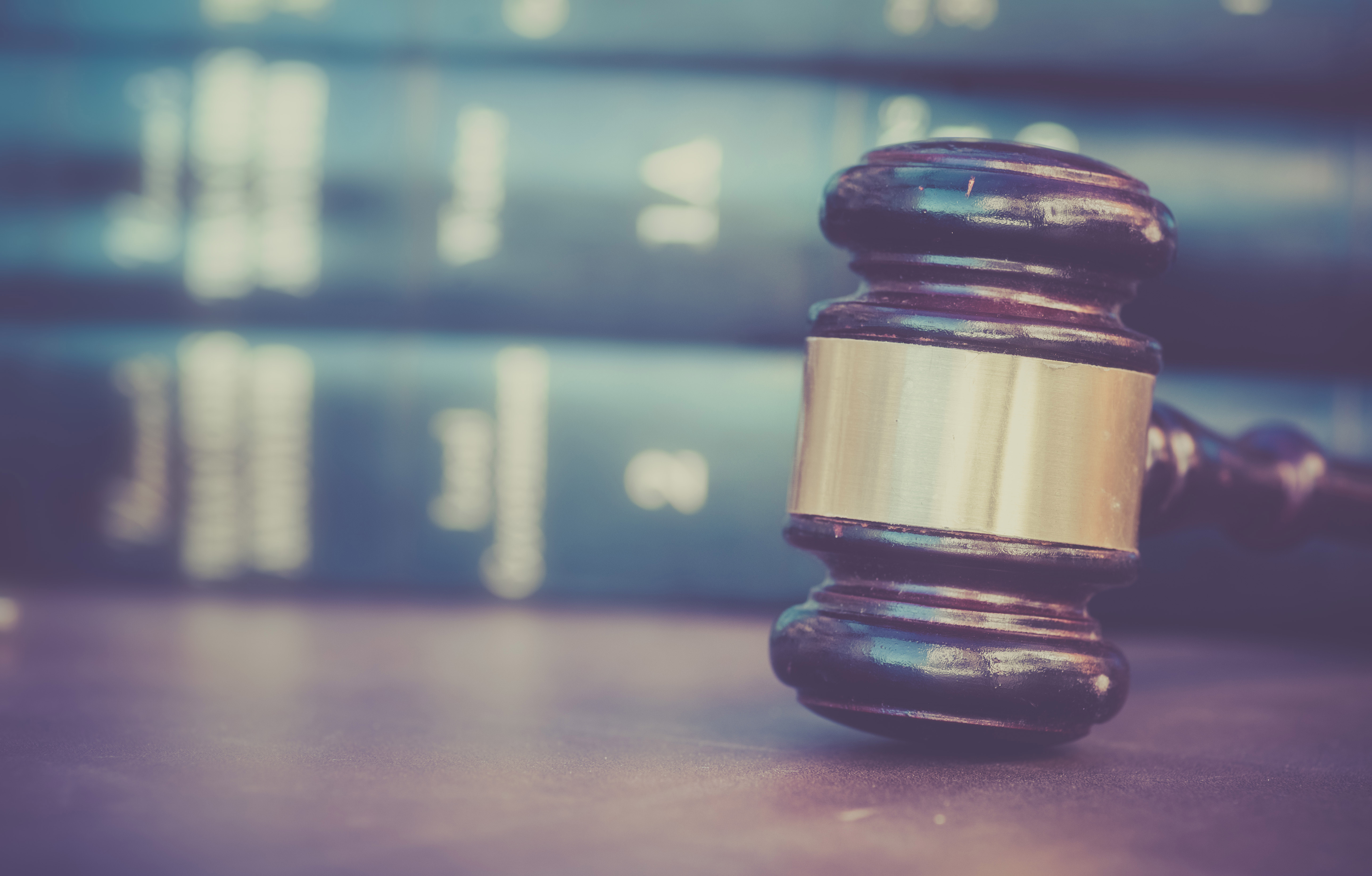 judge's gavel in front of a stack of law books