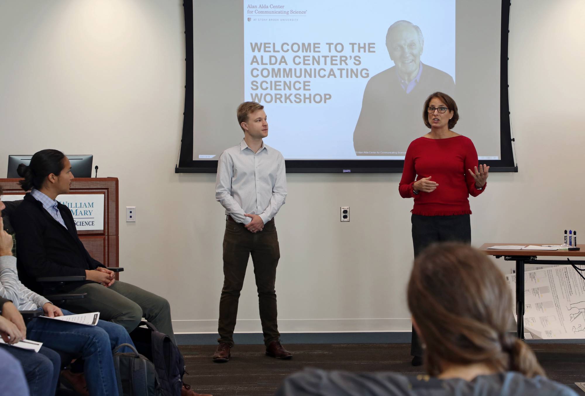 Two instructors stand in front of a classroom at the start of an Alda Center science communication program