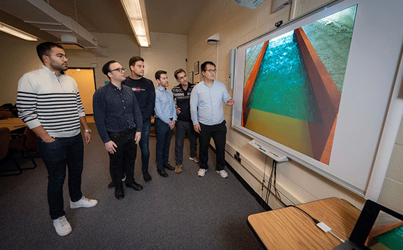 Students watching Professor Khosronejad teach on SMART Board