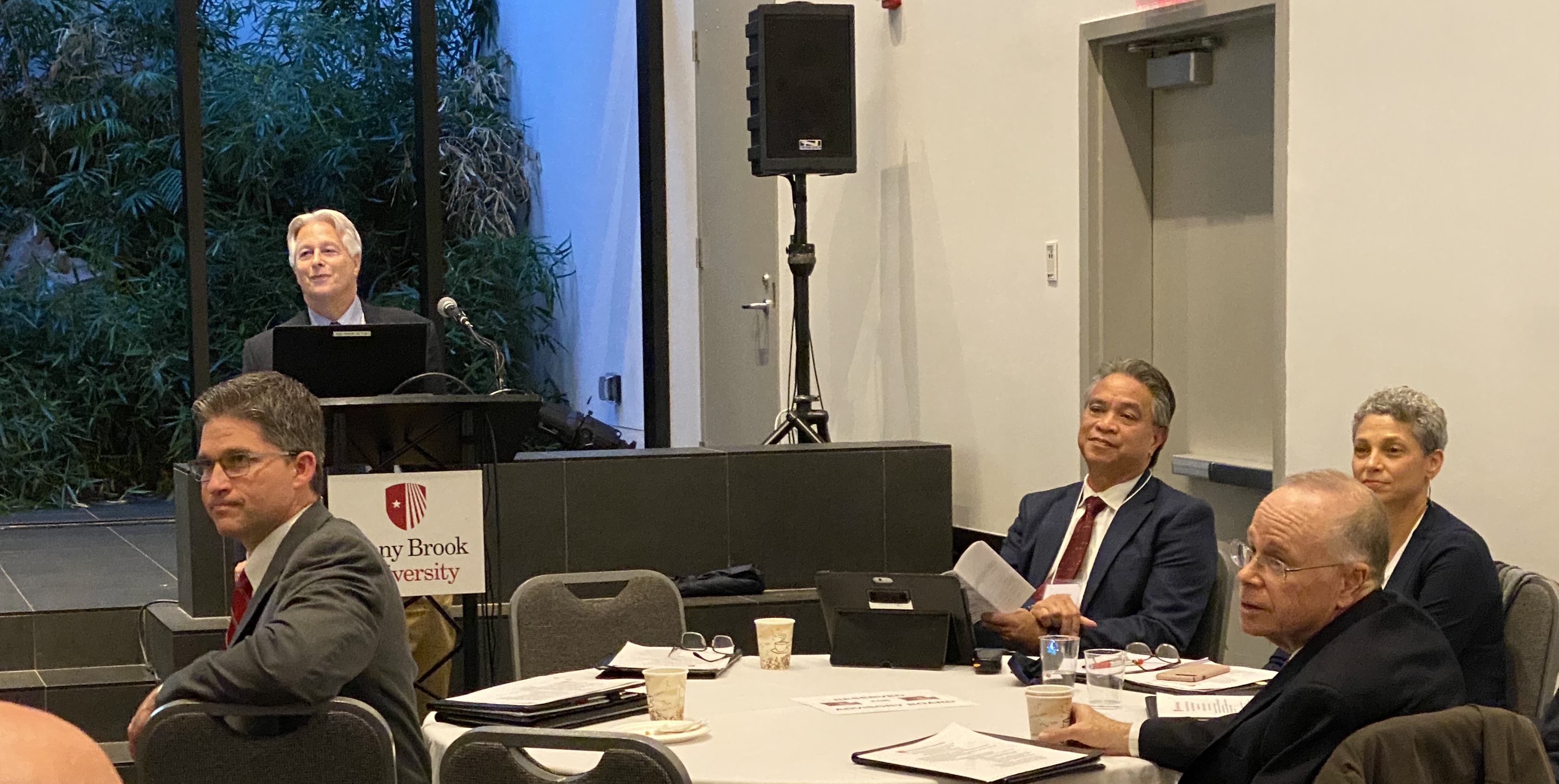 Shot of four advisory board members around a table plus Dr. Terry Earley